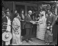 Crombie Allen hands key for newly dedicated Mexican Olympic cottage to Mrs. Christine Sterling, Olvera Street, Los Angeles, 1933