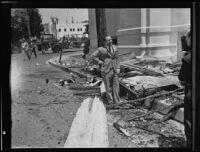 Pastor Harold L. Proppe beside the First Baptist Church of Hollywood after a fire, Los Angeles, 1935