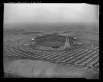 Aerial view of a crowd filled Anaheim Stadium and surrounding area on it's opening day April 9, 1966