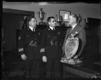 Theodore A. Winston presents trophy to James E. Davis and Roy Steckel, Los Angeles, ca. 1935