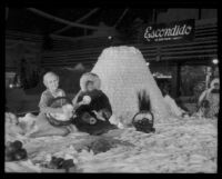 Pat Graham sits on the Escondido display at the National Orange Show, San Bernardino, 1934