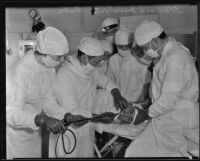 Doctors surround Olin Everts as they insert a tube through his mouth to investigate his stomach, Fresno, 1936