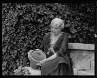 Mrs. Albert Sherman Hoyt posing with cactus plant, South Pasadena, 1931