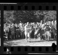 Arnold Palmer and crowd watching flight of his golf ball at the Los Angeles Open, 1964