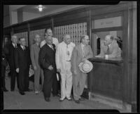 Postmaster Henry B. R. Briggs waits on businessmen J. B. Van Nuys, James Rathwell Page, Ben R. Meyer, J. W. Elliott, and Stiles O. Clements, Los Angeles, 1935