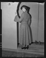 Woman models checkered coat at the Times' fashion show, Los Angeles, 1935