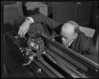 Technician manipulating a component on a Wirephoto machine, Los Angeles, 1935