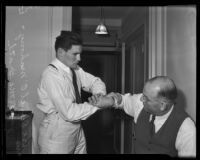 Danno O'Mahony arm wrestles with his manager, Jack McGrath, Los Angeles, 1935