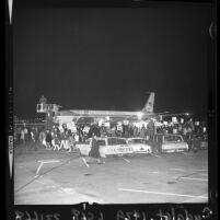 Anti-war demonstrators wave signs at President Lyndon B. Johnson's plane at LAX, 1966