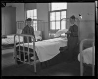 Two boys making a bed at the Lark Ellen Home for Boys, Sawtelle (Los Angeles), 1924