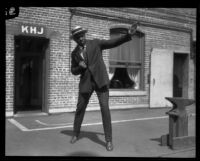 George Godfrey, heavyweight boxer, strikes a boxing pose [outside the KJH Radio studio, Los Angeles(?)], circa 1926-1927