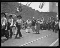 Consuela Castillo De Bonzo and mayor John Porter in a procession celebrating the opening of an extension of Spring street, Los Angeles, 1932