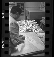 John C. Tarin, street sign painter laying out letters for Spanish named streets in Glendale, 1964