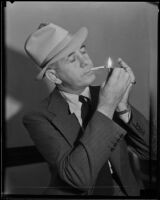 Jack Kearns, boxing manager, lighting a cigarette