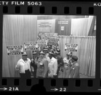 United Auto Workers delegates with pickets reading "Stop Plant Closings UAW-I.P.S.", Calif., 1977