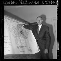 R. B. Rose of the Pacific Telephone Company explaining map outlining toll calls in Alhambra, Calif., 1965