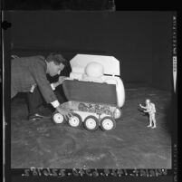 William Sponsler, designer working with one-sixth scale model of a Lunar Surface Vehicle, 1964