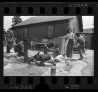 Youths painting at St. Elmo's Village community art center in Los Angeles, Calif., 1975