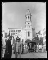 Lt. Col. Vincent Harris and the Rev. Edward McDonnel, St. Vibiana's Cathedral, confer as Marines unload from trucks in Los Angeles, Calif., 1960