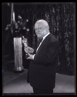 Carl Laemmle holding an Oscar trophy, Los Angeles, 1930