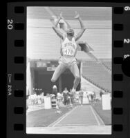 Mike Powell mid-leap in long jump, 1986