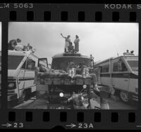 People sitting on couch and atop RVs at the 1985 Long Beach Grand Prix, Calif