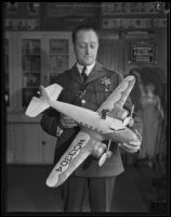 Captain Clem Peoples, Los Angeles County jailer, holds a model airplane, Los Angeles, 1920-1939