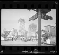 View from across Pershing Square of construction on skyscrapers in Los Angeles, Calif., 1966