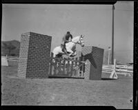 H. W. Christiansen jumping a country club gate at the Griffith Park Riding Academy, Los Angeles, 1932