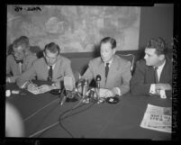 California Congressman Donald L. Jackson seated with three unidentified men at press conference in Los Angeles, Calif., 1953