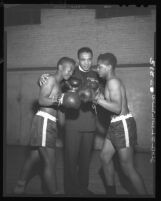 Reverend Samuel Odell Jones, formerly Sammy Odell, coaches boxers Benny Jones and Bobby Delgardo in Los Angeles, Calif., 1948