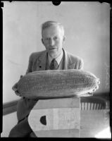 Roland C. Casad shows off his gourd carving, Los Angeles, 1925