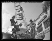 Don't Girl Marion Townsend, demonstrates how not to climb fire engine ladder in Pasadena, Calif., 1948