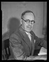 Colonel Halsey E. Yates seated at a desk upon assumption of new duties with the U. S. Army reserve, Los Angeles, 1935