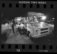 Customers at taco catering truck in Los Angeles, Calif., 1987