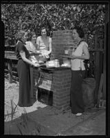 Mrs. Guenther, Miss. Schweitzer, Mrs. Stewart, and Mrs. Reinard grill breakfast in the garden, Los Angeles, 1935