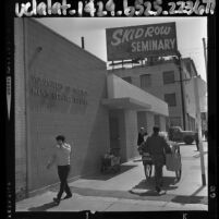 Men walking by entrance to Los Angeles' Skid Row Volunteers of America Men's Service Center, 1964