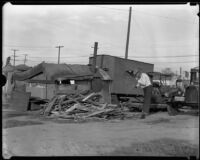 Resident of Hooverville chops wood for fire, Los Angeles, 1930s