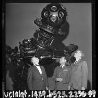 William Frederickson, Charles Yeager and Dr. C. H. Cleminshaw standing before Griffith Park Observatory's new planetarium projector, Los Angeles, 1964