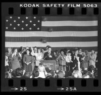 Presidential candidate, Gary Hart at podium surrounded by supporters at Beverly Wilshire Hotel in Los Angeles, Calif., 1984