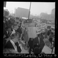 Pickets, on the steps of the Federal Building in downtown Los Angeles, protesting funding cuts for anti-poverty programs, 1967