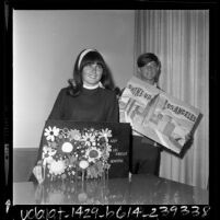 Two teenagers displaying their winning anti-litter posters in Los Angeles Beautiful contest, 1968