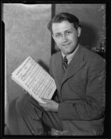 Composer Franz Steininger holding sheet music for the piano, Los Angeles, 1935