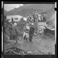 Cleanup or rescue in a canyon neighborhood after a mudslide, Los Angeles, 1969