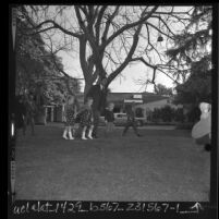 Harold A. Abeles, leading Mickey Rooney's children from home where their mother, Carolyn Mitchell was found dead, Brentwood (Los Angeles), 1966