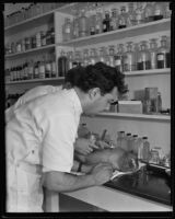 Dr. Ralph Willard performing medical resurrection experiment on a frozen monkey, Los Angeles, 1935