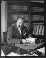 Judge Ellis Egan sits at desk, California, 1926-1939