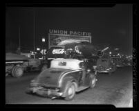 Airplane being transported down Wilshire Blvd. to the Ambassador Hotel in Los Angeles, Calif., 1937