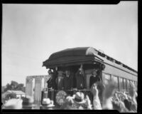 Lou Henry Hoover and Herbert Hoover wave to crowd, Los Angeles, ca. 1928