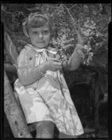 Mary Lou Carter with the blooming wisteria plant, Sierra Madre, 1936